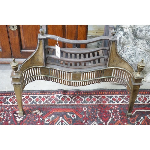 12 - A Thomas Elsley Georgian style serpentine brass mounted cast iron fire grate, lacking back plate, wi... 