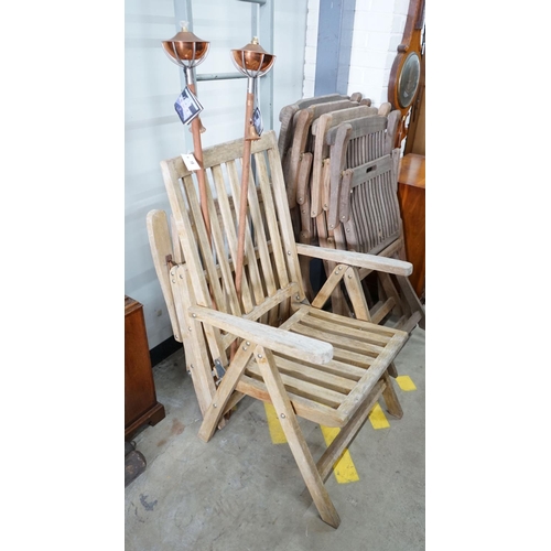 18 - Four weathered teak folding garden chairs, a pair of teak reclining elbow chairs and a pair of Arist... 