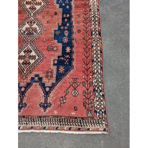 27 - A Caucasian style blue ground geometric rug, 215 x 155cm