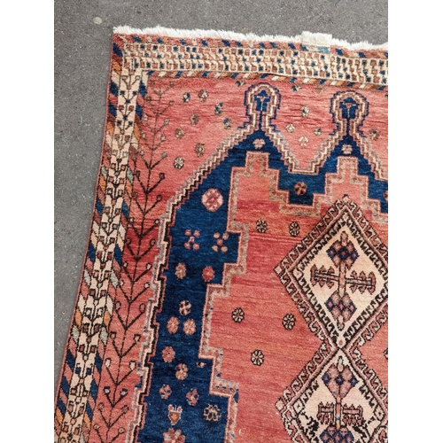 27 - A Caucasian style blue ground geometric rug, 215 x 155cm