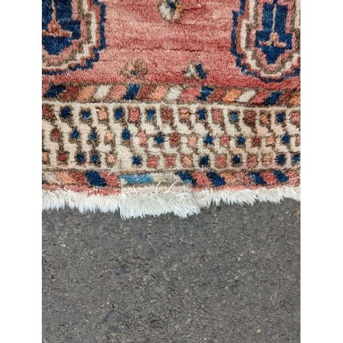 27 - A Caucasian style blue ground geometric rug, 215 x 155cm