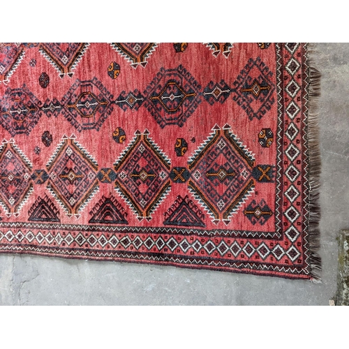 58 - A Caucasian style red ground rug, 255 x 167cm