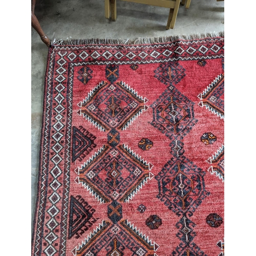 58 - A Caucasian style red ground rug, 255 x 167cm