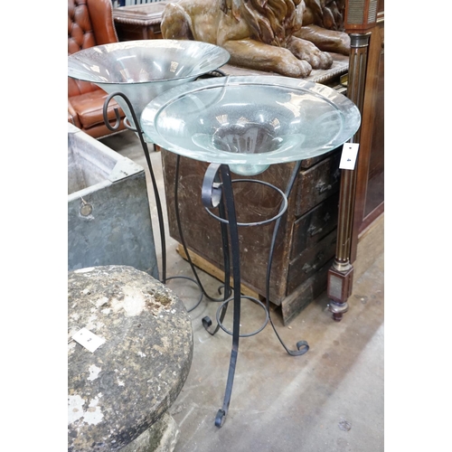 1004 - A near pair of circular glass bowls on wrought iron stands, tallest 103cm