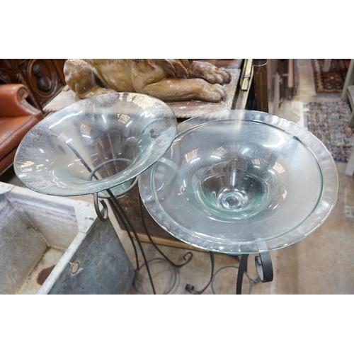 1004 - A near pair of circular glass bowls on wrought iron stands, tallest 103cm