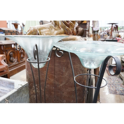 1004 - A near pair of circular glass bowls on wrought iron stands, tallest 103cm