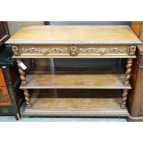 1012 - A late Victorian carved oak three tier buffet, width 115cm depth 44cm height 98cm