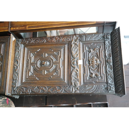 1018 - A carved oak narrow cupboard, width 60cm depth 28cm height 176cm