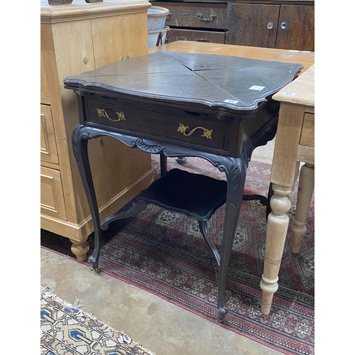 1020 - An Edwardian ebonised envelope card table, width 58cm height 74cm