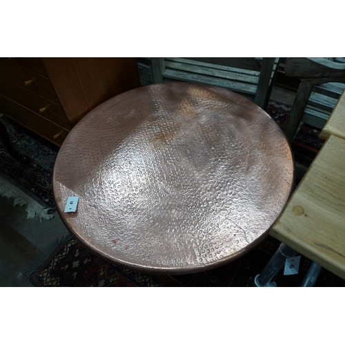 1041 - A circular hammered copper and wrought iron low table, diameter 88cm height 49cm