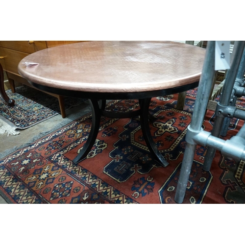 1041 - A circular hammered copper and wrought iron low table, diameter 88cm height 49cm