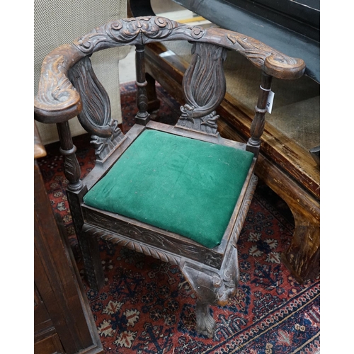 1070 - A Victorian carved oak corner elbow chair