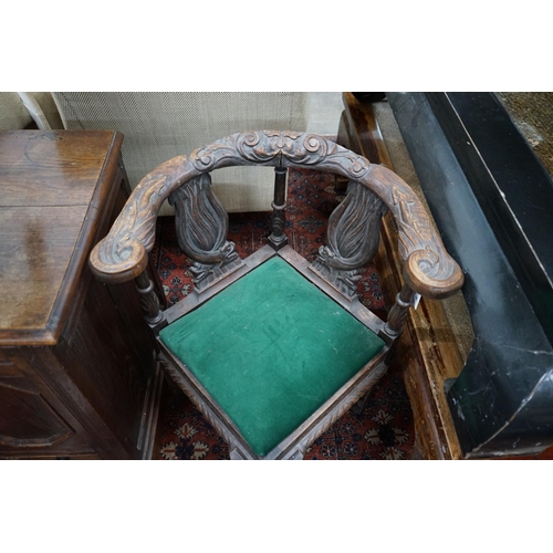 1070 - A Victorian carved oak corner elbow chair