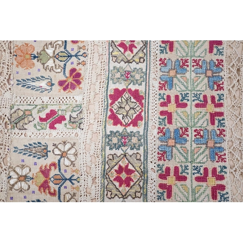 1419 - A 19th century Greek Islands polychrome silk embroidered runner on cram linen, with silk and linen b... 