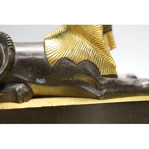 1425 - A parcel gilt bronze model of a sphinx on a Siena marble base - 22cm long