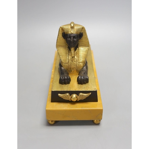 1425 - A parcel gilt bronze model of a sphinx on a Siena marble base - 22cm long