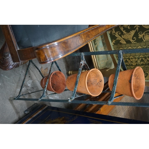 1077 - A wrought iron six tier pot stand, together with six terracotta pots, height 143cm