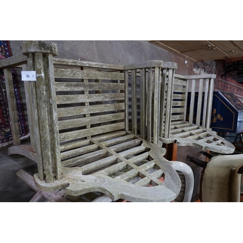 1079 - A pair of Lutyens style weathered teak garden armchairs, width 90cm depth 54cm height 105cm... 