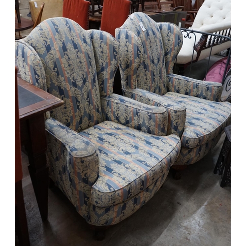 1088 - A pair of 1920's upholstered wing armchairs, width 74cm depth 70cm height 106cm