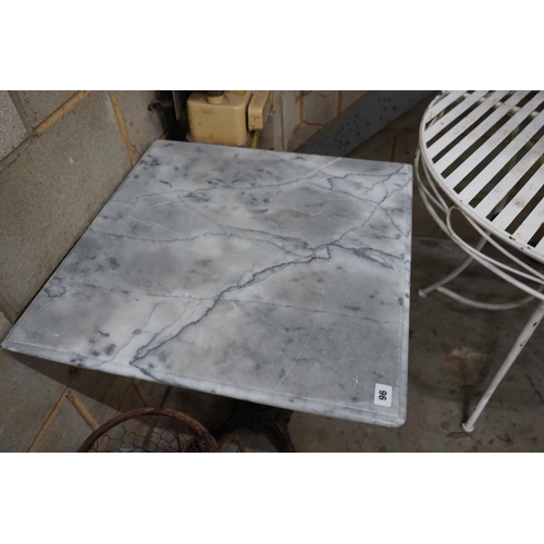 1096 - A reconstituted marble and cast iron garden table, width 60cm height 73cm