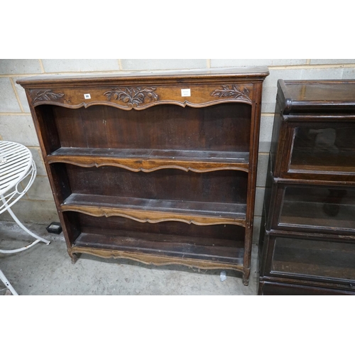 1098 - A French Provincial style walnut open bookcase, width 120cm depth 22cm height 118cm