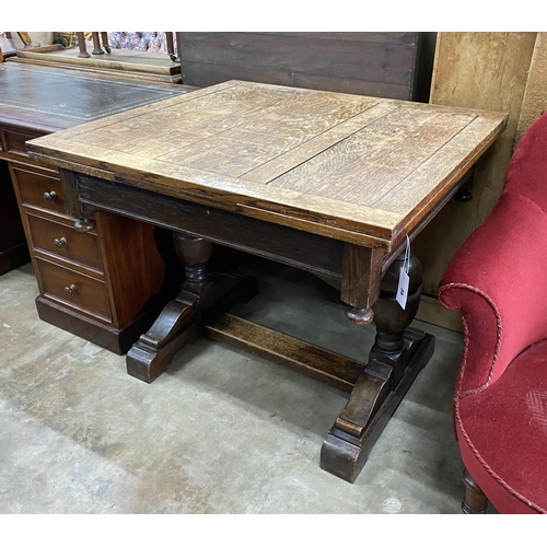 1104 - A 1930's oak draw leaf dining table, length 92cm, width 84cm, height 76cm