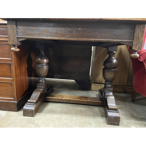 1104 - A 1930's oak draw leaf dining table, length 92cm, width 84cm, height 76cm