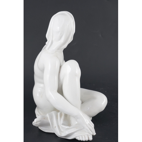 113 - Robert Ullmann (1903-1966) for Meissen, a white glazed porcelain figure of a seated female nude, blu... 