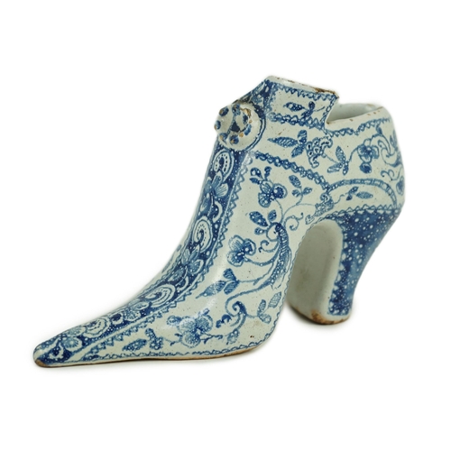 119 - A documentary English delftware blue and white model of a shoe, dated 1732, painted with bands of fl... 