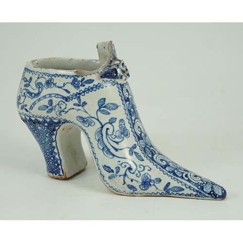 119 - A documentary English delftware blue and white model of a shoe, dated 1732, painted with bands of fl... 