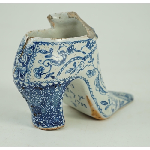 119 - A documentary English delftware blue and white model of a shoe, dated 1732, painted with bands of fl... 