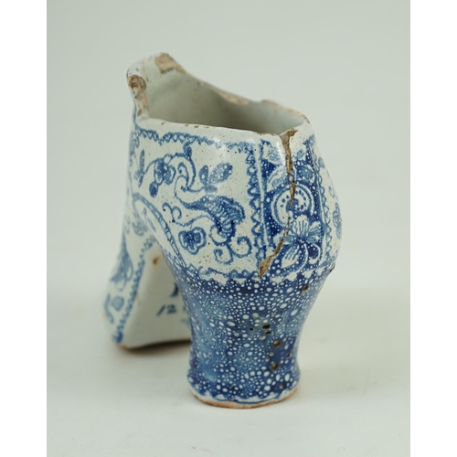 119 - A documentary English delftware blue and white model of a shoe, dated 1732, painted with bands of fl... 