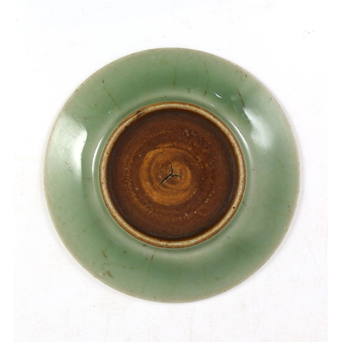 156 - A Chinese celadon glazed small peony dish, Qing dynasty, moulded in relief with a peony flower and s... 