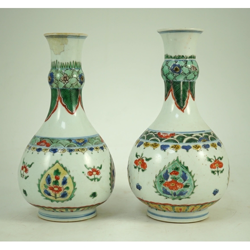 159 - A near pair of Chinese famille verte garlic-neck vases, Kangxi period, each painted with flowers wit... 