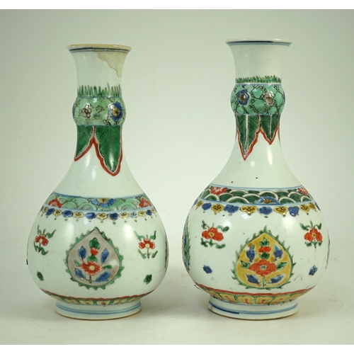 159 - A near pair of Chinese famille verte garlic-neck vases, Kangxi period, each painted with flowers wit... 