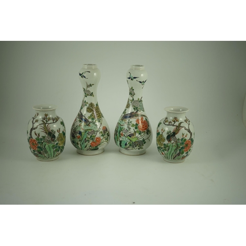 164 - A garniture of four Chinese famille verte vases, 19th century, each painted with pheasants amid rock... 