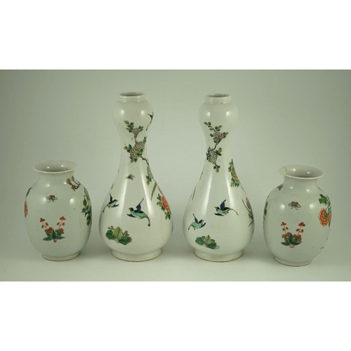 164 - A garniture of four Chinese famille verte vases, 19th century, each painted with pheasants amid rock... 