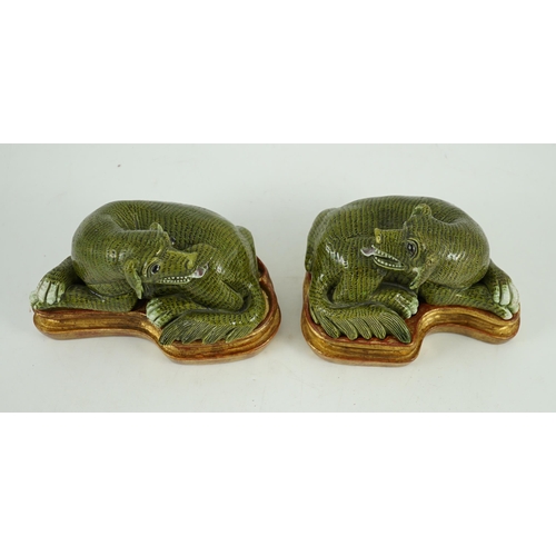 171 - A pair of Chinese green glazed models of hounds, 19th century, each with open mouth and protruding t... 