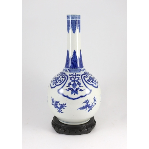 176 - A large Chinese blue and white bottle vase, 19th century, painted with leaf and flower sprays and fl... 