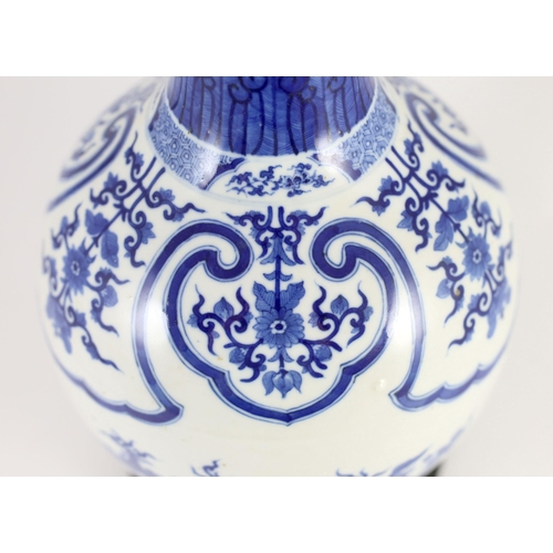 176 - A large Chinese blue and white bottle vase, 19th century, painted with leaf and flower sprays and fl... 