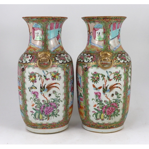 186 - A pair of Chinese famille rose vases, 19th century, typically painted with figures amid pavilions an... 