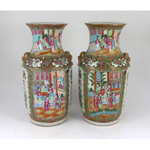 186 - A pair of Chinese famille rose vases, 19th century, typically painted with figures amid pavilions an... 