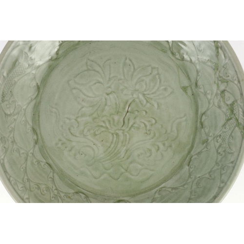 189 - A rare large Chinese Ming Longquan celadon dish, 14th century, the centre carved with lotus flowers,... 