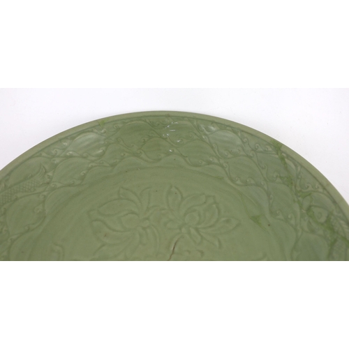 189 - A rare large Chinese Ming Longquan celadon dish, 14th century, the centre carved with lotus flowers,... 