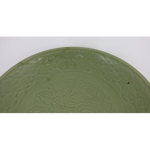 189 - A rare large Chinese Ming Longquan celadon dish, 14th century, the centre carved with lotus flowers,... 