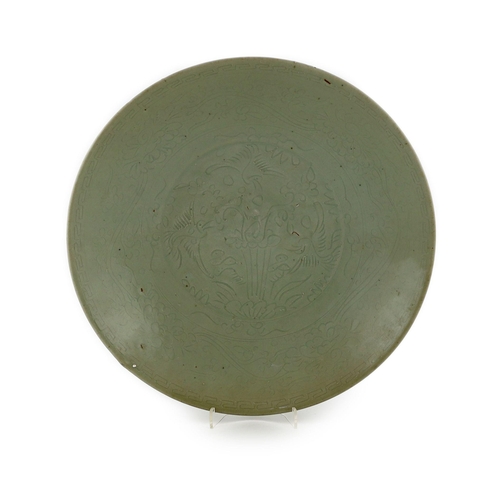 198 - A Chinese celadon glazed sgraffito dish, Zhangzhou kilns, late 16th/early 17th century, incised with... 