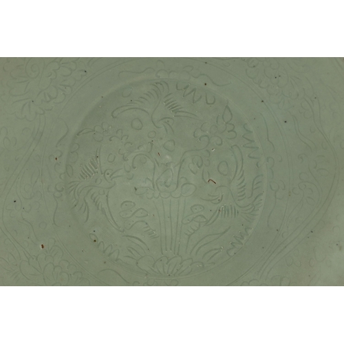 198 - A Chinese celadon glazed sgraffito dish, Zhangzhou kilns, late 16th/early 17th century, incised with... 