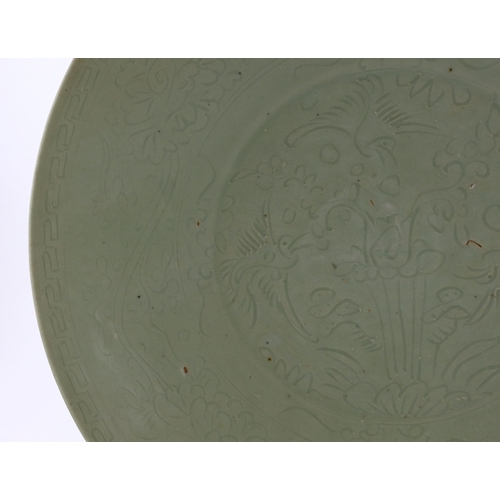 198 - A Chinese celadon glazed sgraffito dish, Zhangzhou kilns, late 16th/early 17th century, incised with... 