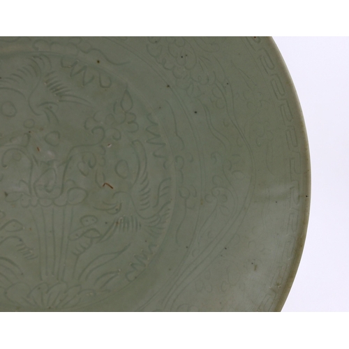 198 - A Chinese celadon glazed sgraffito dish, Zhangzhou kilns, late 16th/early 17th century, incised with... 