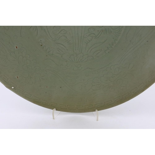 198 - A Chinese celadon glazed sgraffito dish, Zhangzhou kilns, late 16th/early 17th century, incised with... 